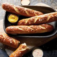 House Baked Soft Pretzels · Salted pretzels with white cheese sauce, yellow mustard, and sriracha ranch.