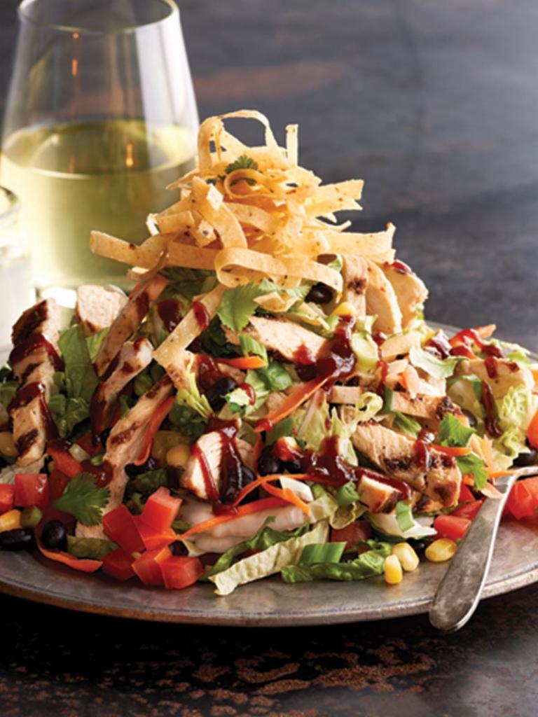 BBQ Chicken Salad · Grilled chicken with roasted corn, black beans, jicama, tomato, green onions, cilantro, and crisp corn tortilla strips. Topped with house-made ranch dressing and whiskey BBQ sauce.