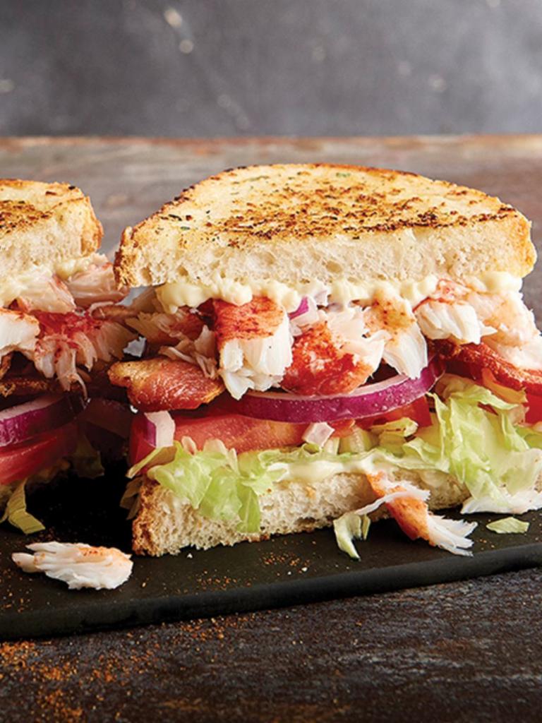 Lobster BLT · Lobster claw meat, Applewood-smoked bacon, sliced tomatoes, shredded lettuce, red onion, and Parmesan-crusted sourdough bread.