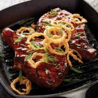 Drunken Pork Chops · Brined center-cut pork chops topped with whiskey barbecue glaze and served with garlic Parme...