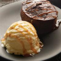 Chocolate Excess Cake · Rich chocolate mini-bundt cake filled with dark chocolate and topped with vanilla ice cream ...