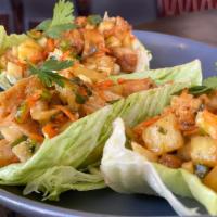 Kona Chicken Lettuce Wraps · Crispy sweet & spicy chicken tenders with grilled pineapple-jicama salsa in fresh lettuce cu...