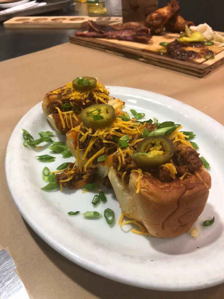 Sloppy Joe Sliders · Our signature 50/50 beef and bacon blend slow-cooked and topped with potato chips, shredded cheddar and pickled jalapeños on grilled King's Hawaiian Rolls.