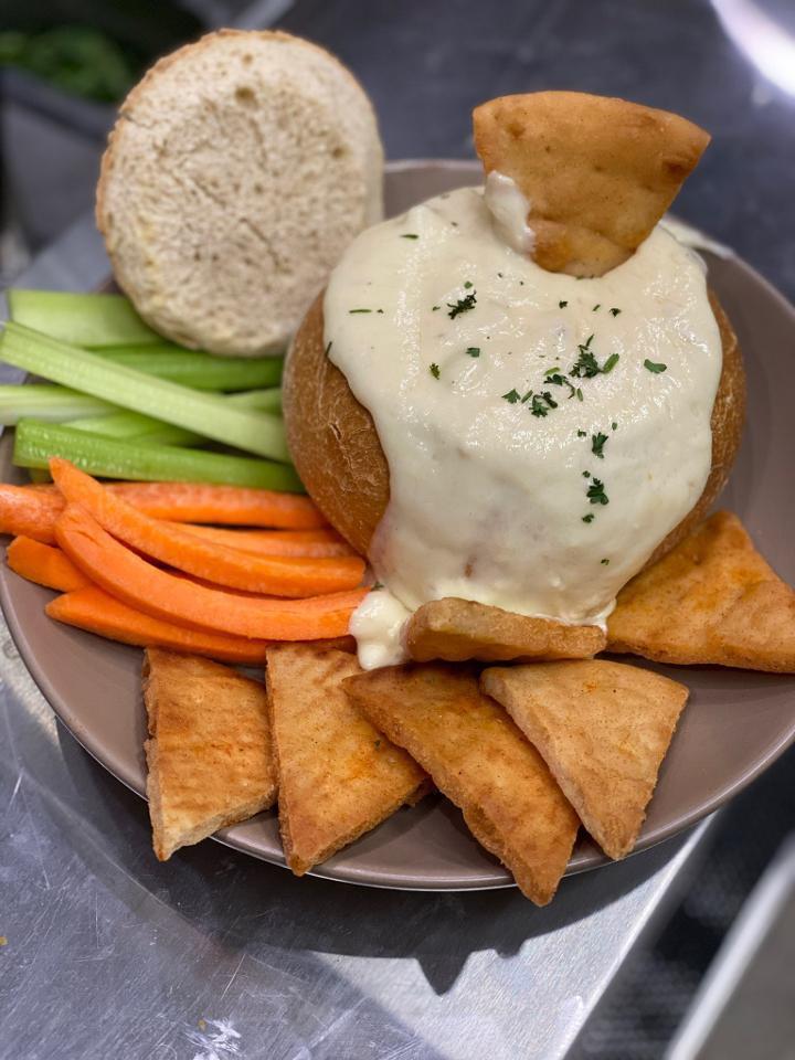Vampire Dip · Roasted garlic and artichoke hearts blended with creamy melted cheese, served in a sourdough bread bowl with crispy pita and veggies for dipping.

NOTE* Togo is served cold with heating instructions to ensure the best quality product!