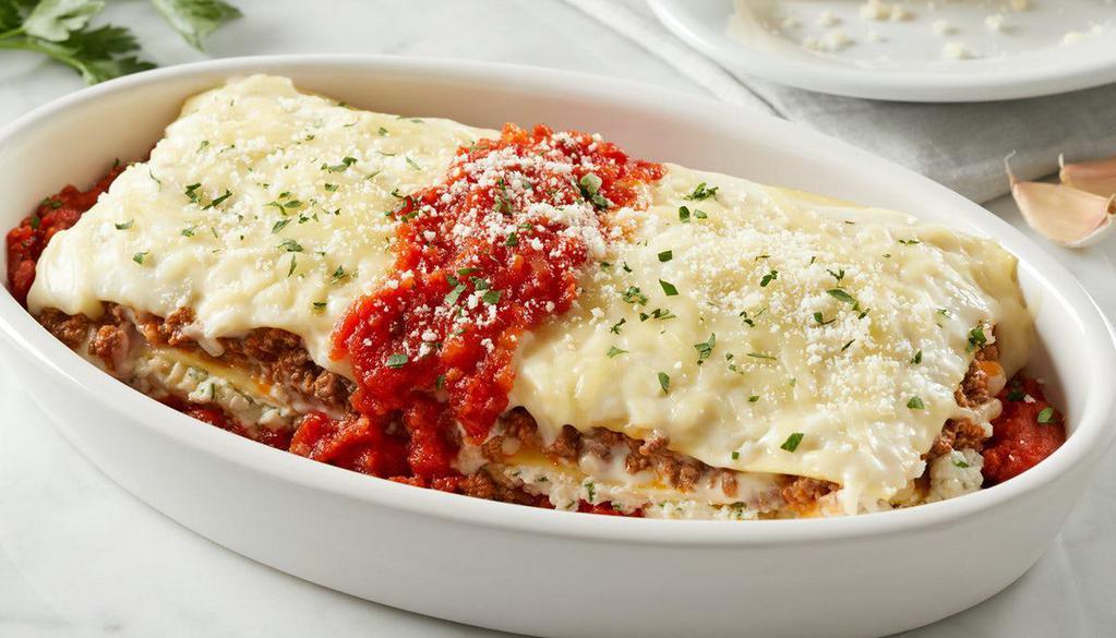 Lasagna · Oven-baked pasta layered with authentic Bolognese meat sauce, ricotta & mozzarella