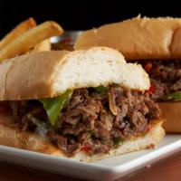 Philly Steak Sandwich · Shaved ribeye, bell peppers, yellow onions, white american cheese, hoagie roll