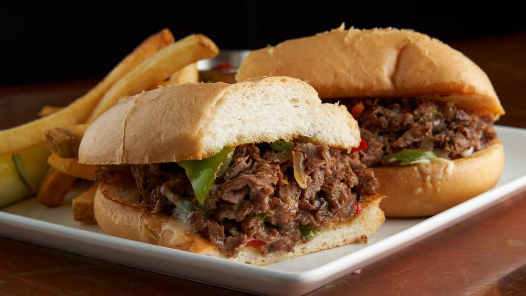 Philly Steak Sandwich · Shaved ribeye, bell peppers, yellow onions, white american cheese, hoagie roll