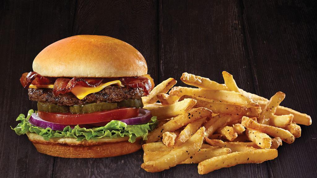 Mega Bacon Cheeseburger · Two 1/3 lb. patties, topped with cheese and bacon. Bistro sauce, shredded lettuce, tomatoes, red onions and dill pickles on a delicious bun. Served with Idaho steak fries.