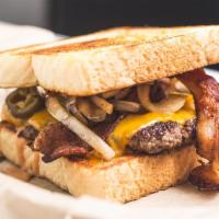 Big Tex Burger · Texas toast, steak sauce, bacon, cheddar, grilled onions and jalapenos.