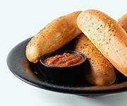 Breadsticks · Four toasted breadsticks brushed with garlic butter, dusted with Parmesan and herbs served with a side of our house made red sauce.