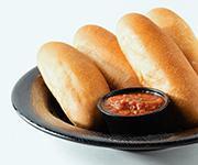 Vegan Breadsticks  · 4 fresh from the oven breadsticks served with our house-made red sauce. Ask for no dust!