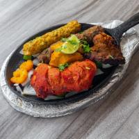 56. Aladdin Platter · Mix grill.Combination of tikka, tandoori chicken, shish kabab, lamb tikka and shrimp.