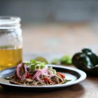 Carnitas Taco · Roasted pork, charred tomato salsa, pickled red onion, cotija, cilantro.