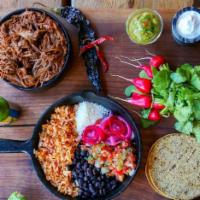 Barbacoa Plato · Pasilla chili braised beef tenderloin with rice, beans, salad, 3 mini tortillas, cotija chee...