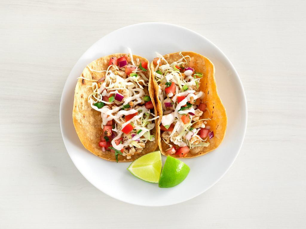 two taco plate · serves 2 | baja fish tacos with creamy jalapeno slaw, and roasted corn pico de gallo | served on warm corn tortillas. substitute crispy chickin - no charge.
