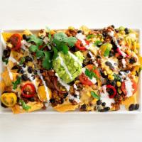 southwestern nachos  · serves 2 |corn chips, queso sauce, tex-mex style taco meat, ranchero beans, roasted tomato c...