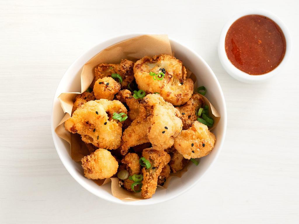 crispy cauliflower · serves 2 | tempura battered cauliflower topped with sesame seeds and green onions. includes choice of buffalo or orange dipping sauce. 