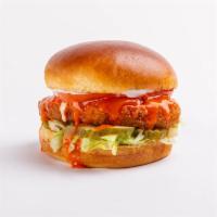 crispy buffalo chickin' sandwich · crispy chickin’ topped with creamy ranch, buffalo sauce, lettuce, tomato and pickles on a br...