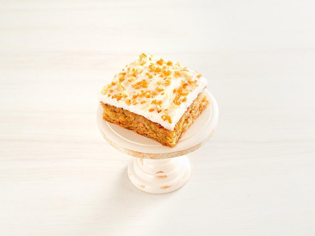 carrot cake ·  housemade carrot cake topped with cream cheese frosting, walnuts and carrots.