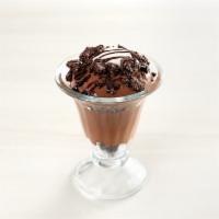chocolate pudding parfait · layers of chocolate pudding and chocolate cookie crumbles, crema, and chocolate syrup.