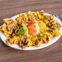 Nachos Supreme · Our nachos regulares topped with fajita meat, sour cream and guacamole.