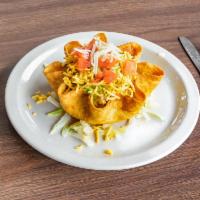 Taco Salad · A crispy tortilla shell ÿlled with seasoned taco meat or chicken on a bed of lettuce with to...
