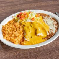 Burrito Dinner  · 2 burritos smothered in chile con queso, served with rice, beans, lettuce and tomatoes. 