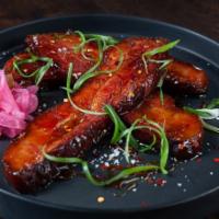 Bacon Candy · Slow-braised bacon, sweet and salty glaze, pickled red onion and red chili flakes.