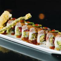 Rodeo Roll · Onion tempura, green bean tempura, avocado and pickled radish inside topped with seared rib-...
