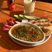 Charred Eggplant Dip · Charred Eggplant Dip topped with toasted pistachio, berbere spice, and herbs. Served with ri...