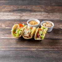 Taco Dinner  · Three tacos on soft corn tortilla with choice of meat. Served with rice and beans.