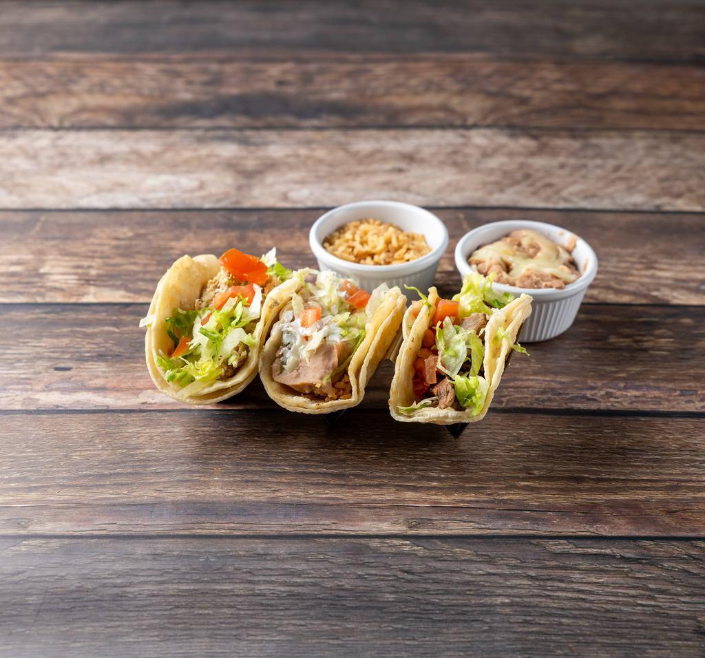 Taco Dinner  · Three tacos on soft corn tortilla with choice of meat. Served with rice and beans.