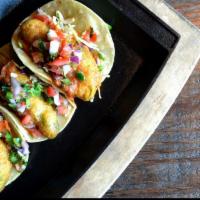 Vegan Crispy Avocado Street Taco · Three mini corn tortillas filled with crispy beer battered avocado, cabbage slaw, roasted ch...