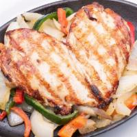 Pechuga De Pollo · Mesquite grilled chicken breast with sautéed peppers and onions. Serve with homemade guacamo...