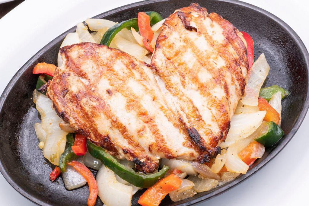 Pechuga De Pollo · Mesquite grilled chicken breast with sautéed peppers and onions. Serve with homemade guacamole, pico de gallo, Mexican rice and frijoles a la charra