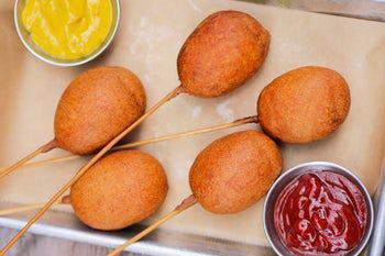 Mini Corn Dogs · Nathan’s All Natural beef hot dogs, corn batter dipped + fried to order, served with our Liquid Blanket IPA mustard + ketchup. 1500 calories.