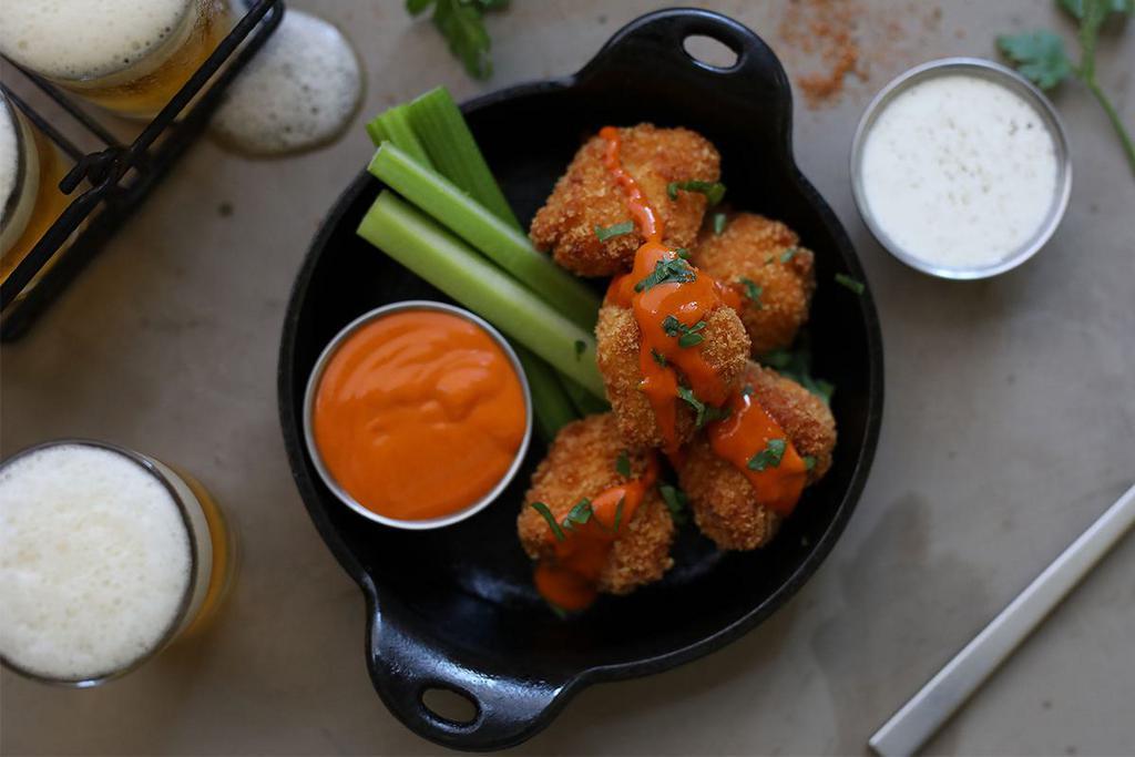 Buffalo Chicken Nuggets · Hand breaded chicken nuggets tossed in Cajun spices, drizzled with high altitude hot sauce, served with celery + ranch. 1390 calories.