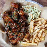 BBQ St. Louis Style Pork Ribs · Tender St. Louis style ribs flash-fried until crispy, brushed with our molasses BBQ sauce, p...