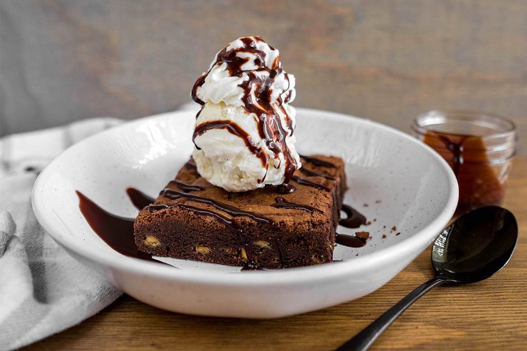 Chocolate Brownie Sundae · Our housemade white chocolate chip brownie served with a side of chocolate syrup and vanilla bean ice cream.