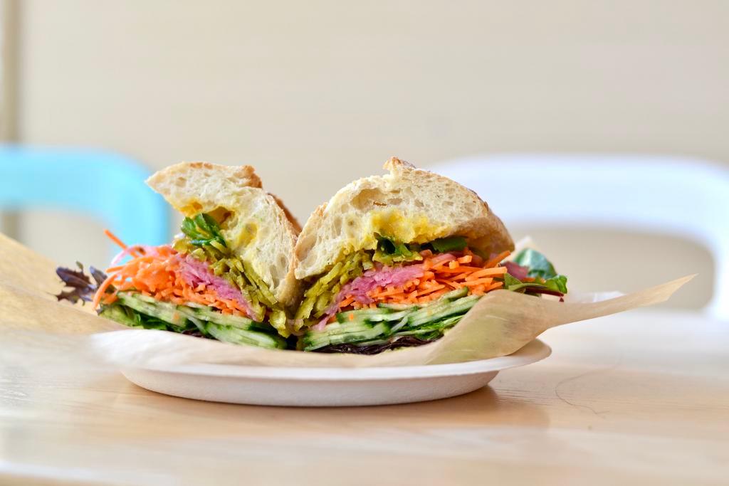Veggie Sandwich · Smashed avocado, carrots, cucumber, pickled red onions, pepperoncini, greens, carrot-cumin dressing!