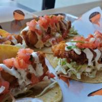 The Classic Fish Tacos · Beer battered ensenada-style, with citrus slaw, fresh pico de gallo and our signature crema ...