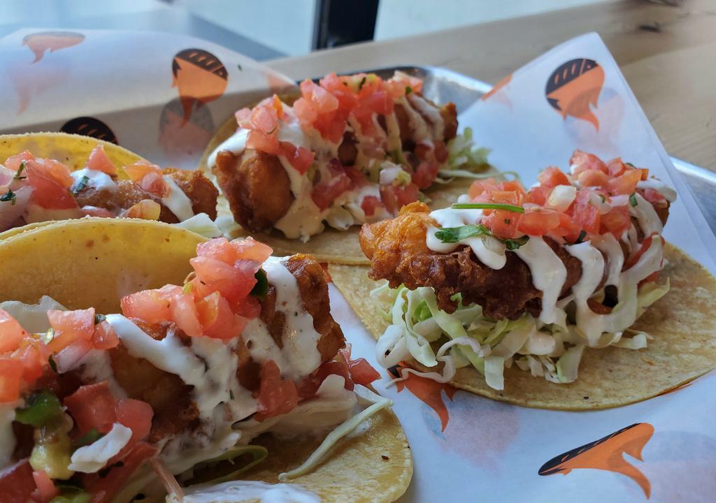 The Classic Fish Tacos · Beer battered ensenada-style, with citrus slaw, fresh pico de gallo and our signature crema on 2 corn tortillas. Served with black beans and our homemade chips and salsa.