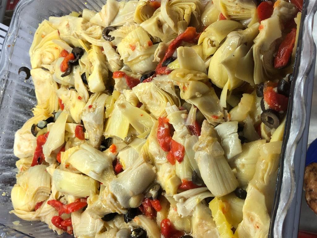 Artichoke salad (8 OZ) · With roasted red peppers, black olives, banana peppers, and mixed in a golden Italian dressing. 