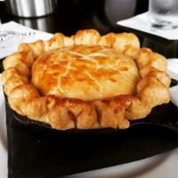 Chicken Pot Pie  · Classic pie crust filled with rotisserie chicken, carrots, onions, peas, and potatoes.