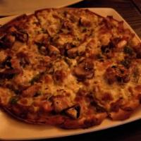 Gluten Free Pizza · Onion, tomato, mushroom, olives, and mozzarella cheese on pesto-covered, GF pizza crust, top...