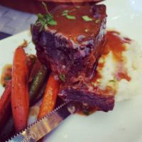 Costillas Asadas · Juicy beef short ribs braised overnight with spices and herbs served with green beans, baby ...