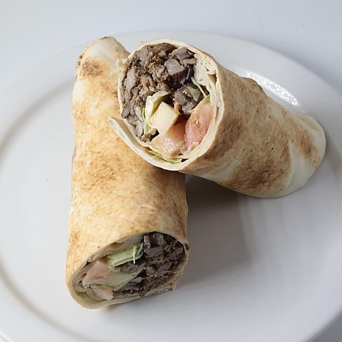 Beef Shawarma Pita Wrap · Slices of seasoned sirloin beef cooked rotisserie-style with tahini sauce, lettuce, cucumbers, shredded carrots, shredded red cabbage and diced tomatoes.