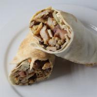 Chicken Shawarma Pita Wrap · Slices of seasoned chicken thigh cooked rotisserie style with garlic sauce, lettuce, cucumbe...