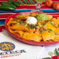 Nachos Azteca Dinner · Azteca's award winning nachos! Crisp, corn tortilla chips topped with beans, jalapenos and m...