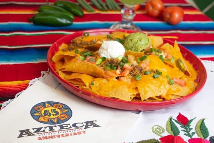Nachos Azteca Dinner · Azteca's award winning nachos! Crisp, corn tortilla chips topped with beans, jalapenos and melted Cheddar cheese. Garnished with tomatoes, green onions, sour cream and guacamole.